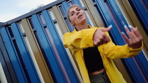 Stylish Woman Dancing Vigorously in an Urban Setting