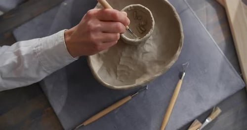 Hands Crafting Pottery in Studio Setting