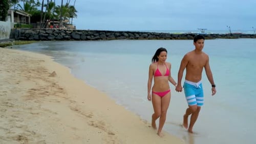 Couple walking on the beach 4k