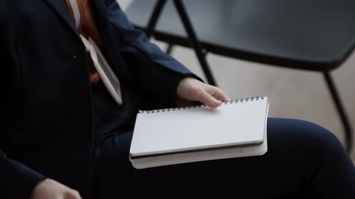 Person Tearing Page out of Notebook