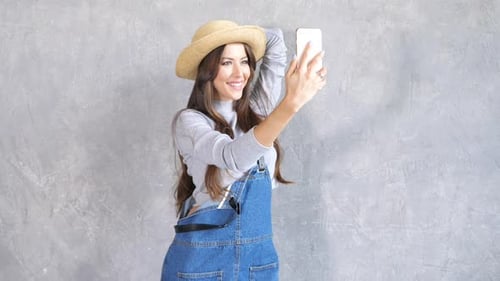 Smiling Woman Posing for Selfie with Phone
