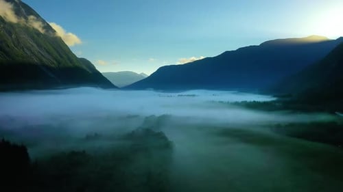 Morning Mist Over the Valley Among the Mountains in the Sunlight