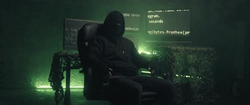 Masked Hacker in Dark Room with Computers
