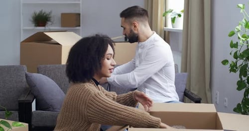 Multiracial Couple Young Family Unpacks Parcels African American Girl and Caucasian Guy Open