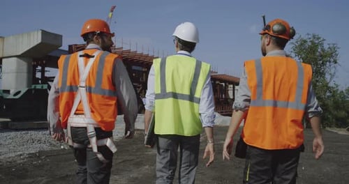 Professional Engineers Walking Towards Unfinished Bridge