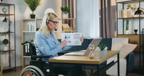 Woman in Wheelchair Presents Business Charts Online