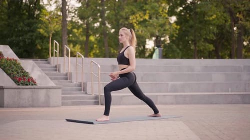 Fitness Woman Practice Yoga Exercises On Mat Outdoor City Street Sunlight Background