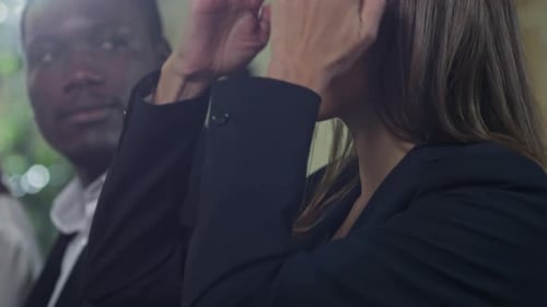 Business Professionals at Conference Taking Notes