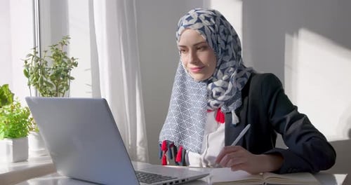 Woman Working on Laptop in Bright Modern Office