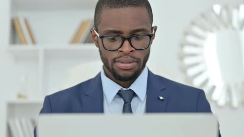 Focused Adult Working on Laptop in Office