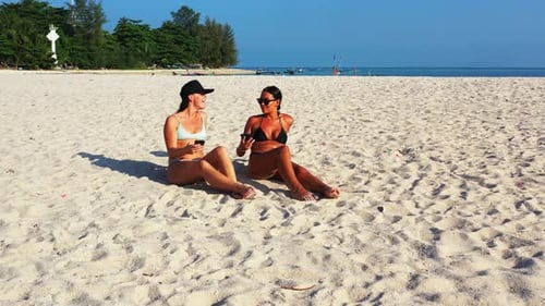 Pretty Smiling Ladies Relaxing Having Fun on The Beach on Summer White Sand and Blue