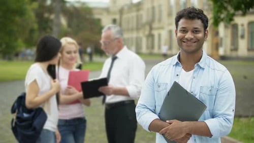 Happy Hispanic Student Standing Near College and Looking Into Camera, Education