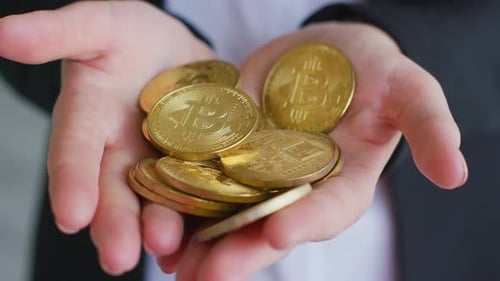 Woman Holding Golden Bitcoin Cryptocurrency Coins Close Up