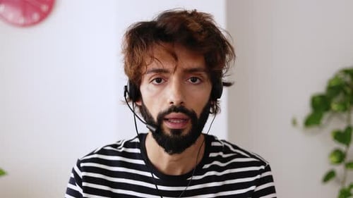 Man Wearing Headset Talking Indoors At Home