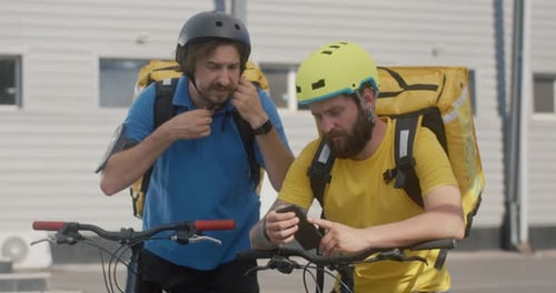 Bike Messengers Check Smartphone
