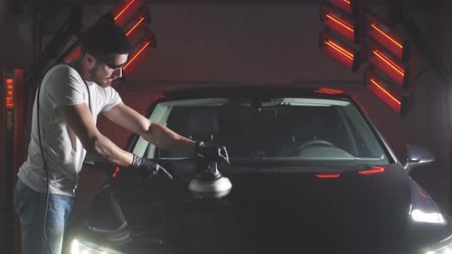 Master Polishes the Car in a Car Workshop