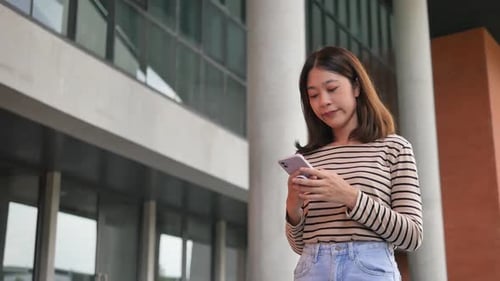 Woman Using Smartphone Outdoors in an Urban Setting