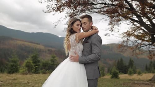 Lovely Young Newlyweds Bride Groom Embracing on Mountain Slope Happy Wedding Couple Family in Love