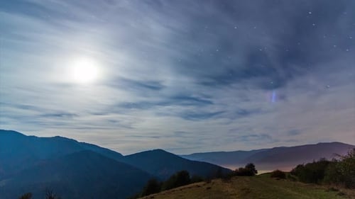 Moonlit Night Sky Over Mountain Range Time-Lapse