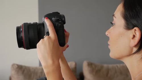 Woman Using a Camera Indoors Close Up
