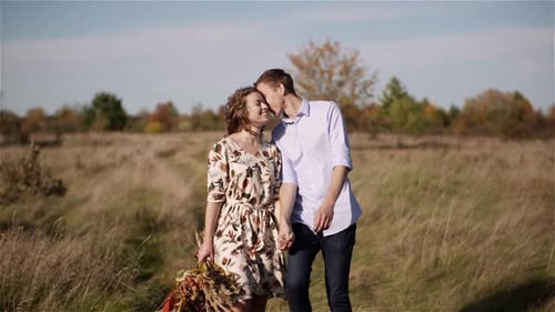 Young Couple Walking on a Meadow