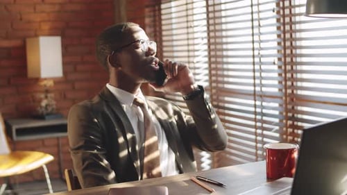 Afro-American Businessman Talking on Phone in Office