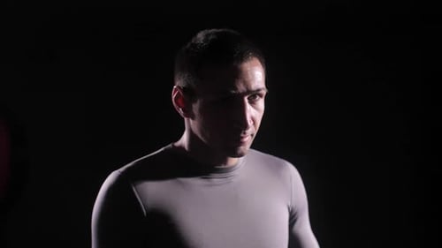 Sweaty Man with Short Dark Hair Wearing Gray Shirt