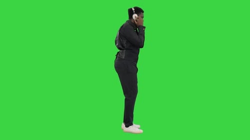 Young Adult Dancing with Headphones on Green Screen
