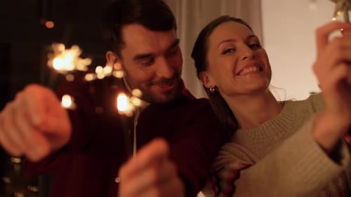 Couple Celebrates Christmas with Sparklers at Home