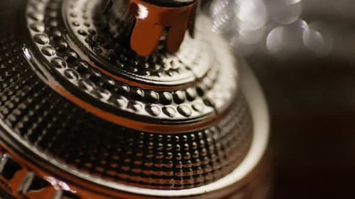 Rotating Top of Ornate Metal Object in Macro