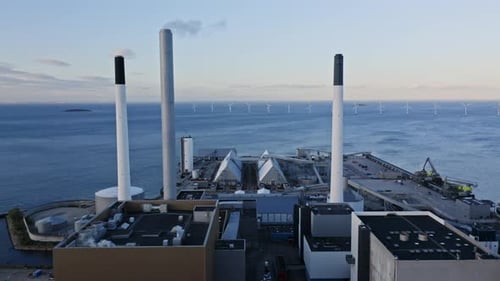 Buildings' Rooftops and a View of the Windmills Surrounded By Ocean Waters