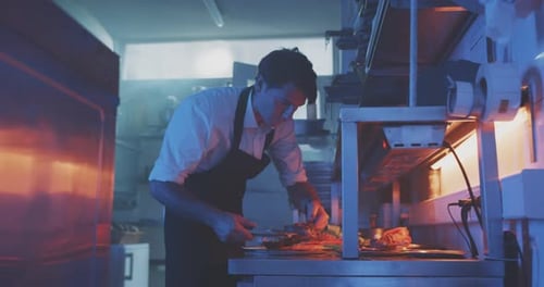 Chef Plating Food in Restaurant Kitchen