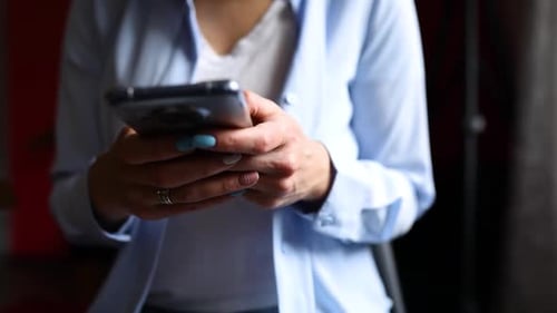 Adult Using a Smartphone Close Up Indoors