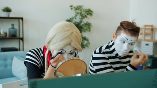 Mimes Applying Makeup Indoors Before Performance
