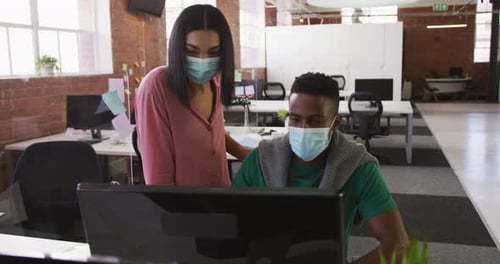 Coworkers Collaborating With Masks in Modern Office