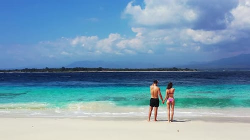 Young Man and Woman Married on Vacation Enjoy Life on Beach on Paradise White Sand