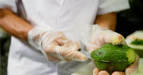 Preparing Avocado on Cutting Board in Restaurant