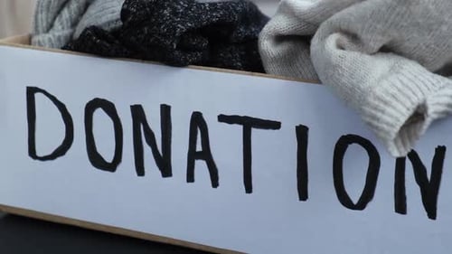 Donation Box with Old Used Clothes Indoors