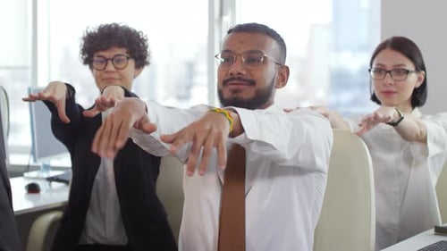 Businesspeople Doing Physical Exercises in Office