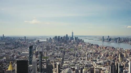 Wide panoramic view of Manhattan with the One World Trade Center and the Statue of Liberty in the di