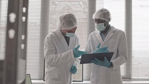 Scientists Consulting Over Lab Results in Lab