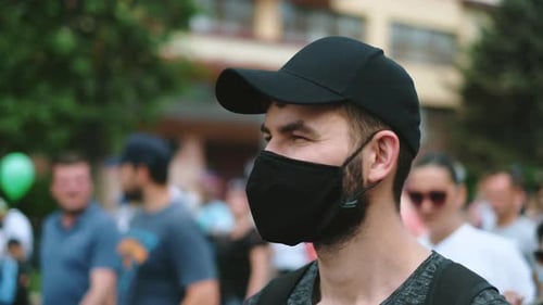 Man with Face Mask in Urban Crowd