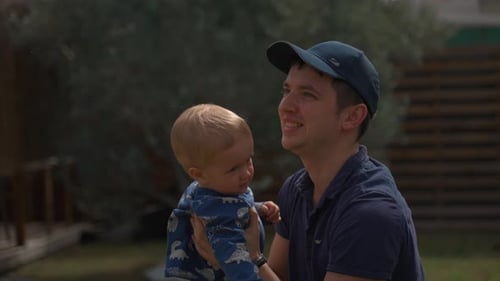 Father Holding His Toddler Up High in the Air