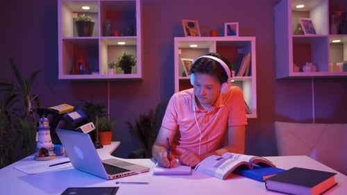 Young Adult Studying With Laptop at Home