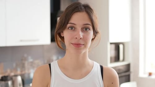 Young Woman Smiling in Modern Kitchen Setting