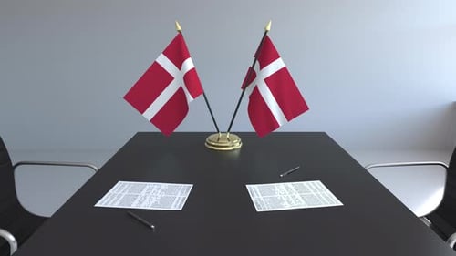 Denmark Flags on Meeting Table with Documents