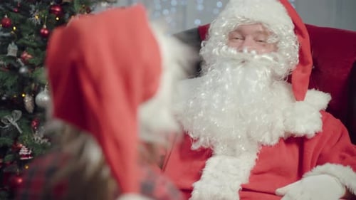 Santa Claus Gives Gift to Child at Christmas