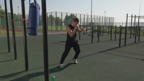 Athletic Young Adult Boxing Outdoors in Urban Setting