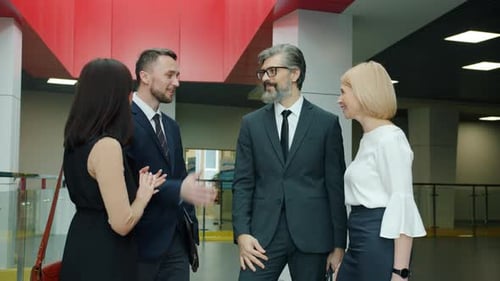 Slow Motion of Happy Business Partners Doing High-five and Smiling in Office Center Hall