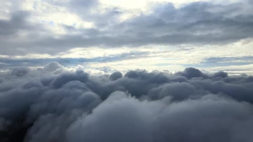 Aerial View From Airplane Window at High Altitude of Earth Covered with Puffy Cumulus Clouds Forming
